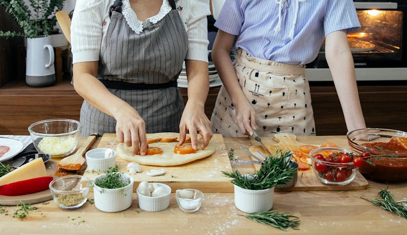 Jet's Pizza team members working together in the kitchen